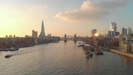 dolly-forward-drone-shot-London-city-centre-tower-bridge-shard-gherkin-at-sunset