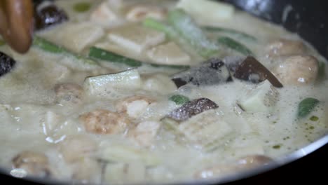 Adding-Table-Spoon-of-Salt-Sugar-from-small-Blue-Bowl-to-Boiling-Thai-Vegetable-Curry