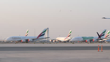 Jet-taking-off-above-grounded-Emirates-A380-planes-at-Al-Maktoum-airport