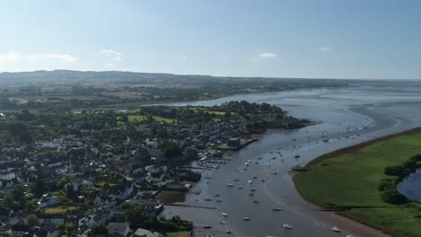 Aerial-of-the-historic-village-of-Topsham-on-the-river-exe,-Dozens-of-boats-moored-on-the-water-way