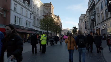 People-walking-urban-shopping-city-Liverpool-street-wearing-pandemic-masks