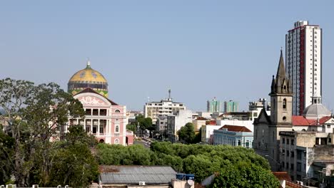 Establishing-shot-of-the-Manaus-City-center-in-Brazil-with-a-view-of-a-church,-the-Opera-House-and-other-buildings---taken-from-a-rooftop