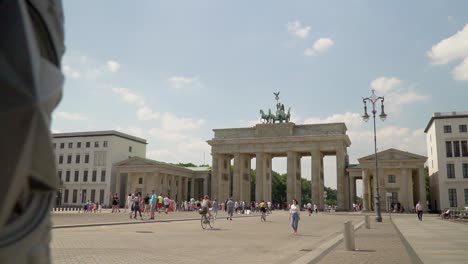 Tourists-at-Brandenburg-Gate-Famous-Monument-in-Berlin,-Germany---Panning-Reveal