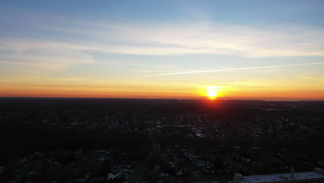 An-aerial-shot-over-a-suburban-neighborhood-during-a-golden-sunrise