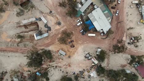 A-high-view-looking-down-at-a-old-pub-and-discarded-mining-equipment-in-the-Australian-outback-of-a-small-mining-town-in-the-opal-capital-of-the-world-Lightning-Ridge