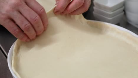 Hands-Preparing-Pie-Pastry-Dough-For-Tart---close-up