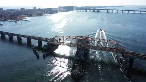 An-aerial-shot-of-a-swing-bridge-over-s-bay-in-Queens,-NY