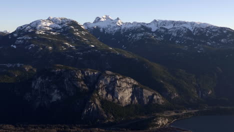 Beautiful-snow-capped-green-rock-mountains-of-Canada--aerial