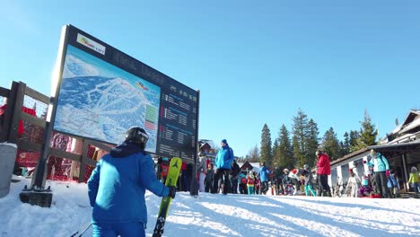 Big-board-with-a-map-loaction-of-skiing-routes-on-the-Szrenica-mountain-in-Szklarska-Poreba-resort-during-winter-school-holidays,-Karkonosze-mountains,-Poland