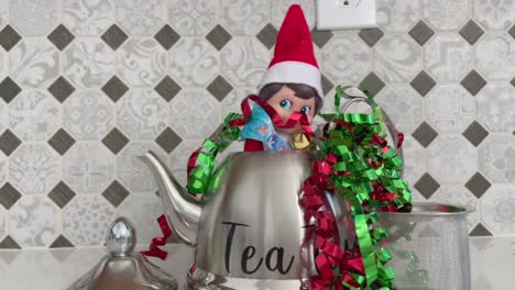 An-Elf-on-the-Shelf-hiding-inside-of-a-silver-teapot