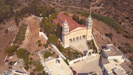 Panning-Aerial-Shot-of-a-Beautiful-Church-on-the-Island-Village-of-Lefkes-Greece
