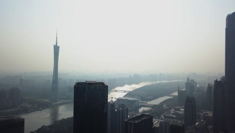 Aerial-shot-of-mega-city-Guangzhou-Central-building-district-with-pearl-river-and-Canton-tower-on-a-sunny-day-in-the-afternoon