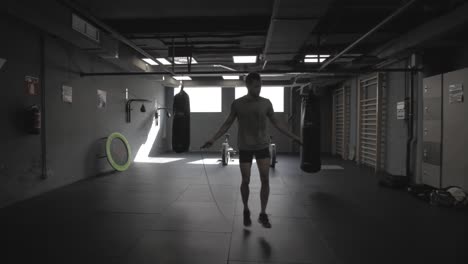 Young-athletic-man-skipping-a-rope-at-the-gym