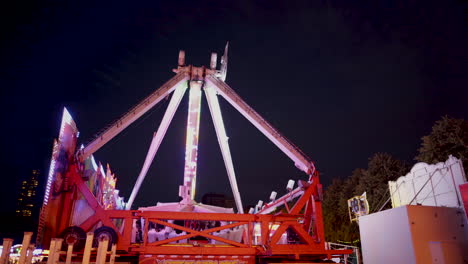 A-giant-swing-is-going-back-and-forth-at-a-fair-at-night