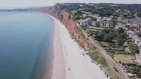 Aerial-STATIC-CROP,-flying-toward-red-sandstone-cliffs-along-the-Jurassic-Coast