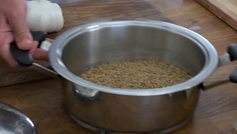 Pouring-lentils-into-a-stainless-pot-and-shaking-before-soaking