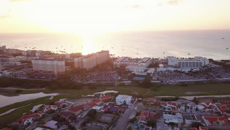 Residential-neighborhoods-behind-massive-hotels-along-the-coast-of-Aruba-during-golden-hour