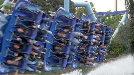 Passengers-on-the-Manta-Roller-Coaster-at-SeaWorld-Orlando-Enjoying-Themselves-as-the-Fly-Around-a-Bend-with-Water-Spraying-Up-From-Beneath-Them,-Super-Slow-Motion