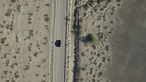 Aerial-Above-Car-Driving-in-Desert