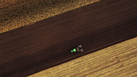 Aerial-top-view-shot-of-Agricultural-machine-driving-in-brown-fields