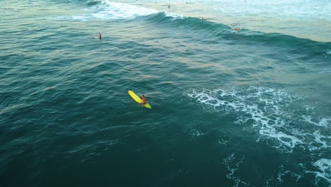 Drone-shot-of-a-man-surfing-in-the-ocean