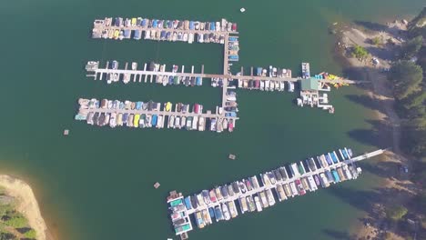 Aerial-flyover-of-a-small-marina-with-docked-boats-at-Shaver-Lake-in-the-California-Sierra-Nevada-mountains