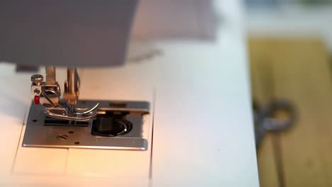 Industrial-sewing-machine-needle-detail-working-up-and-down-in-slow-motion