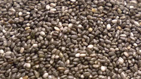 Macro-shot-of-Chia-seeds-being-poured-into-a-pile-that-is-building-up