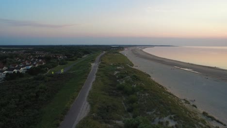 Aerial:-The-beach-around-the-Oosterschelde-storm-surge-barrier-during-a-summer-sunset