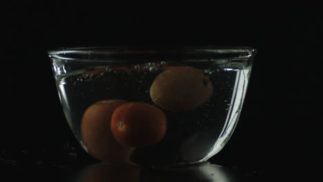 Slow-mo-of-Tomatoes-Dropping-in-Bowl-of-Water