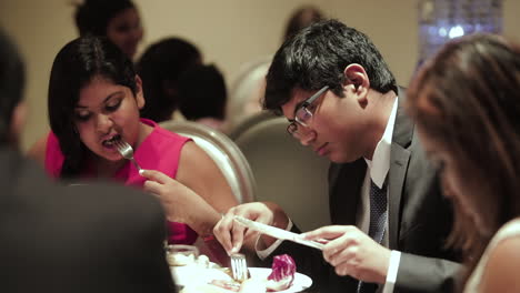 Teenagers-eating-at-a-table-in-a-banquet-hall