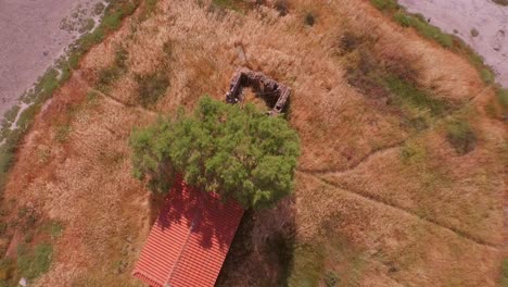 Aerial:-Top-down-view-of-an-abandoned-shed-on-Lesbos,-Greece