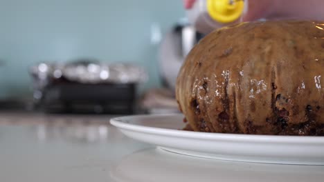 Pouring-Alcohol-Over-Christmas-Pudding-And-Lighting-With-A-Match