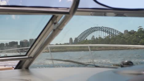 View-inside-a-boat-with-the-harbor-bridge-in-the-background-in-the-windows-during-a-sunny-day