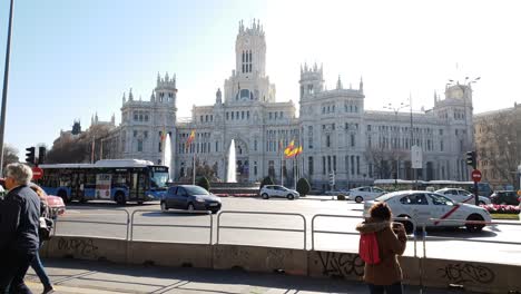 Traffic-rushing-by-in-front-of-Plaza-de-Cibeles-in-Madrid,-this-is-where-Real-Madrid-victories-are-celebrated