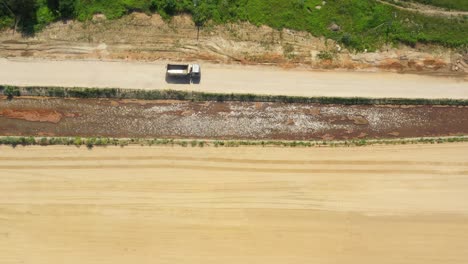 Tod-down-view-of-semi-truck-driving-on-sand