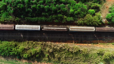 Aerial-video-of-a-freight-train-crossing-the-field,-campinas,-São-Paulo,-Brazil