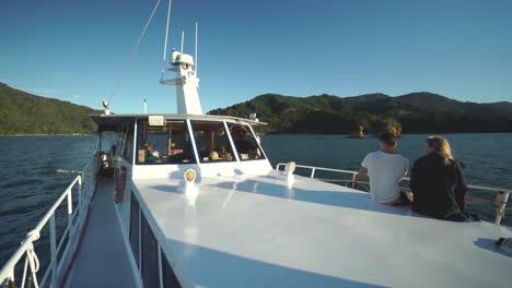 People-enjoying-the-sunset-on-boat-in-Marlborough-Sounds,-New-Zealand