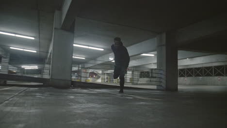 African-American-man-jumping-a-fence-in-a-parking-garage-in-slow-motion