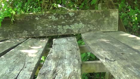 Abandoned-wooden-table-with-bench-in-mountain