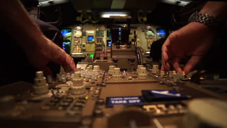 Two-pilots-in-the-cockpit-of-a-Jet-airplane-are-controlling-instruments-during-a-night-flight