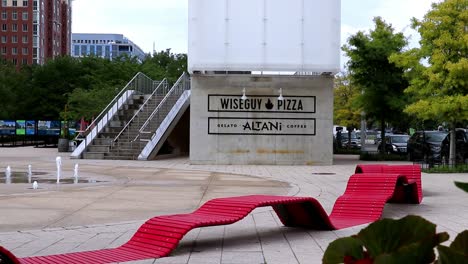 Stylish-modern-red-benches-and-fountains-outside-of-two-restaurants-in-an-urban-setting