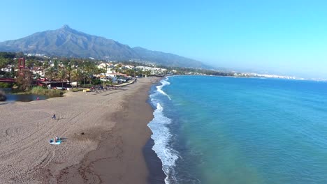 drone-flying-up-view-of-marbella-and-golden-mile-with-beach-and-la-concha-mountain,-beautiful-view-of-the-costa-del-sol