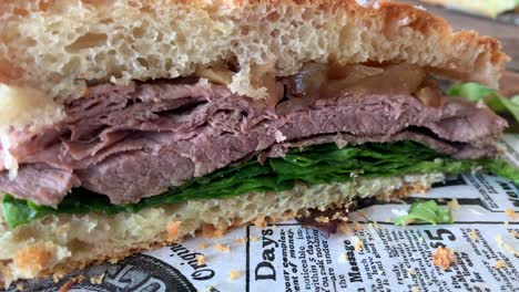 roast-beef-sandwich-made-with-homemade-rustic-bread,-filled-with-caramelized-onions,-spinach-and-a-honey-mustard-sauce,-delicious-lunch-time-food