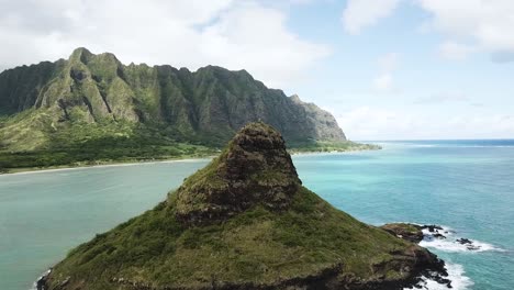 Drone-Shot-approaching-ChinaMan's-Hat-with-the-Kualoa-Mountain-Range-in-the-background