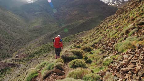 Backpacker-girl-on-a-hike-in-Atlas-mountains,-Morocco