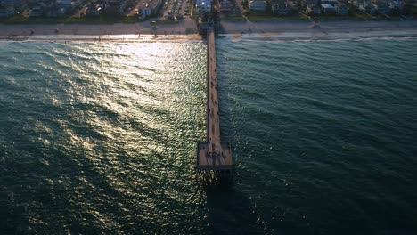 Droning-over-a-public-fishing-pier-in-Wrightsville-North-Carolina-revealing-the-Back-bay