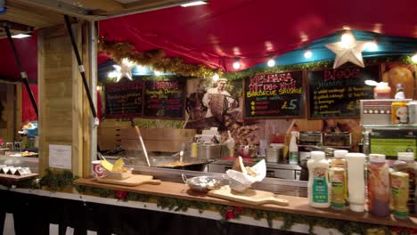 People-ordering---eating-from-Christmas-market-street-food-wooden-traditional-cabin-in-festive-city-attraction