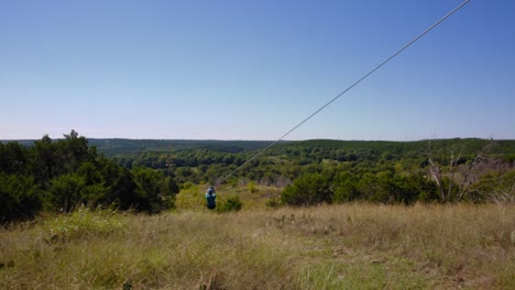 A-young-man-glides-out-across-the-Oklahoma-treetops-on-a-zip-line