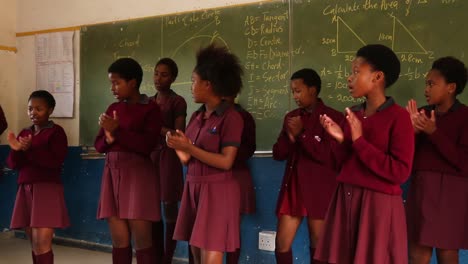 Black-girls-sing-and-clap-together-in-African-high-school-class